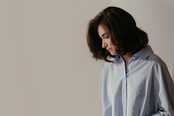 pensive woman in blue shirt