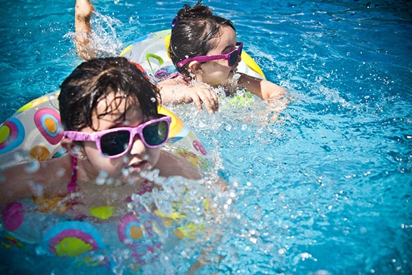 two children swimming in a pool